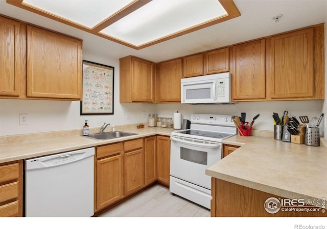 2802 Sundown Ln Unit 102, Boulder, CO 80303 - kitchen featuring white appliances, a sink, and light countertops