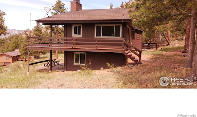 730 Spring St, Estes Park, CO 80517 - rear view of property with a wooden deck, a chimney, a patio area, and stairway