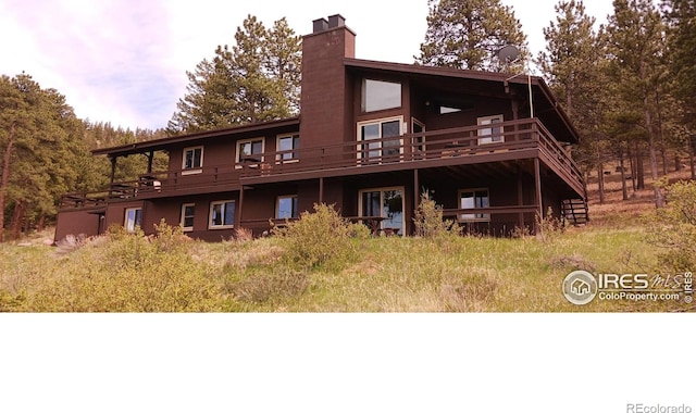 730 Spring St, Estes Park, CO 80517 - back of house with a chimney and a deck