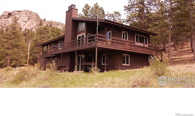 730 Spring St, Estes Park, CO 80517 - rear view of property with a chimney and a deck
