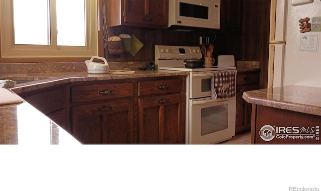 730 Spring St, Estes Park, CO 80517 - kitchen featuring white appliances and light tile patterned floors