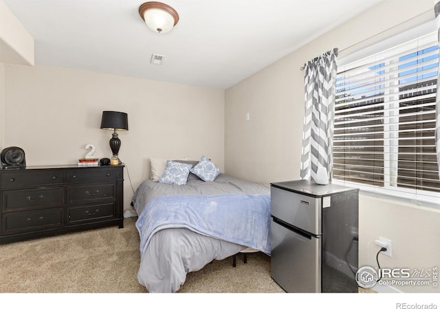 9930 Cascade St, Firestone, CO 80504 - bedroom featuring light colored carpet and freestanding refrigerator