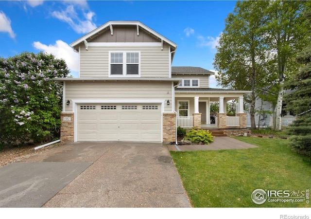 1382 Warbler St, Loveland, CO 80537 - craftsman inspired home featuring a garage, brick siding, driveway, covered porch, and a front yard