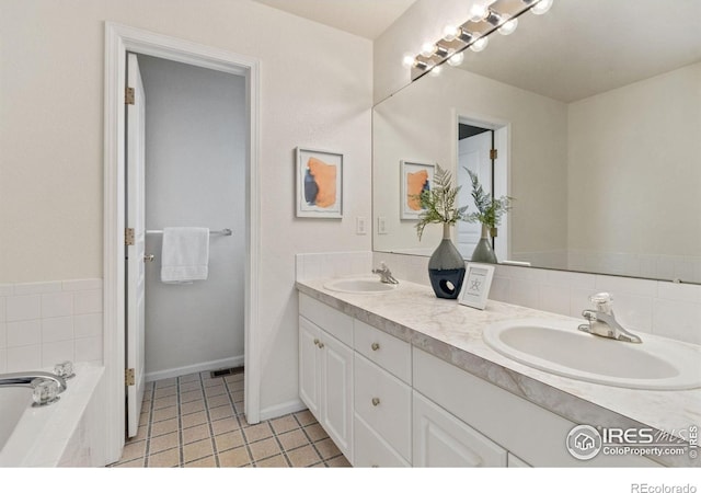 1382 Warbler St, Loveland, CO 80537 - bathroom with double vanity, tile patterned flooring, a bath, and baseboards