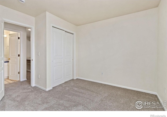 1382 Warbler St, Loveland, CO 80537 - unfurnished bedroom with carpet floors, baseboards, and a closet