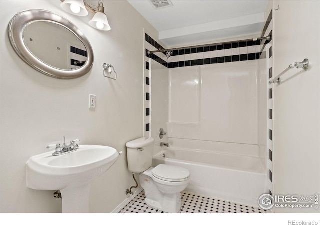 1382 Warbler St, Loveland, CO 80537 - full bathroom with toilet, shower / washtub combination, baseboards, tile patterned flooring, and a sink