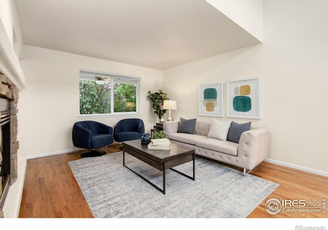 1382 Warbler St, Loveland, CO 80537 - living room featuring wood finished floors, baseboards, and a fireplace