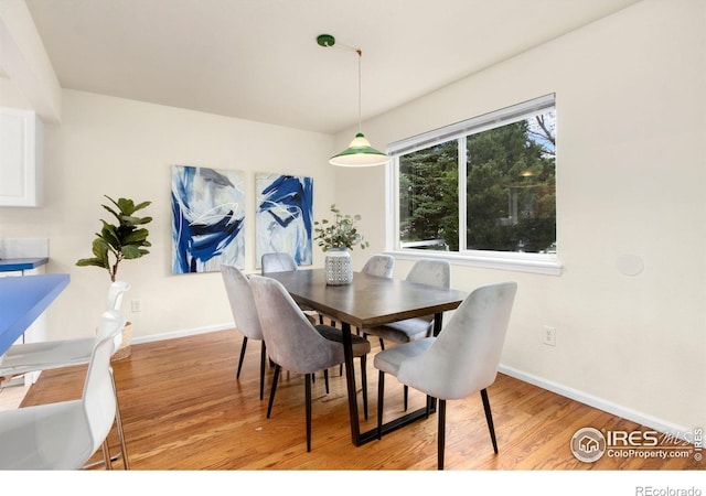 1382 Warbler St, Loveland, CO 80537 - dining room featuring light wood-style floors and baseboards