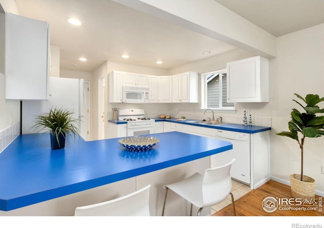 1382 Warbler St, Loveland, CO 80537 - kitchen with white appliances, a sink, white cabinets, and recessed lighting