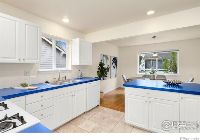 1382 Warbler St, Loveland, CO 80537 - kitchen featuring white dishwasher, a sink, pendant lighting, white cabinets, and recessed lighting