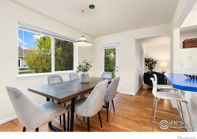 1382 Warbler St, Loveland, CO 80537 - dining room featuring healthy amount of natural light, light wood-style flooring, and baseboards