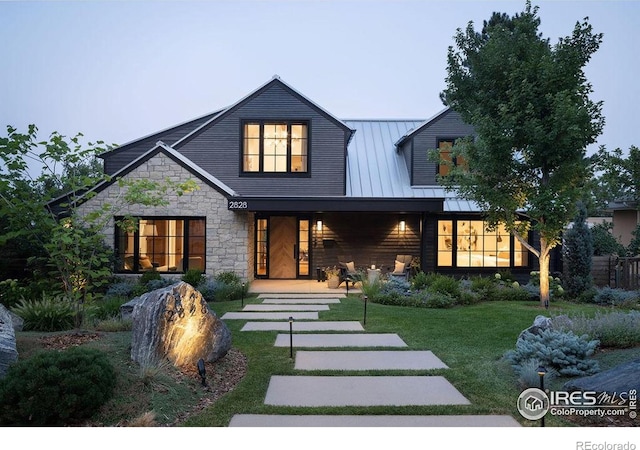 2828 4th St, Boulder, CO 80304 - rear view of property with stone siding, a lawn, covered porch, a standing seam roof, and metal roof