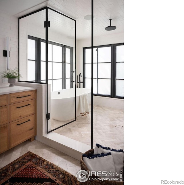 2828 4th St, Boulder, CO 80304 - full bathroom with a soaking tub, vanity, healthy amount of natural light, and a shower