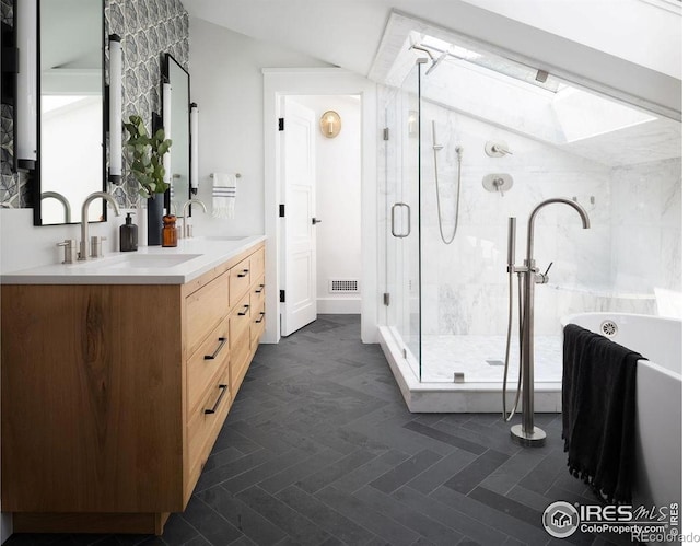 2828 4th St, Boulder, CO 80304 - bathroom featuring a skylight, double vanity, a freestanding tub, a shower stall, and lofted ceiling