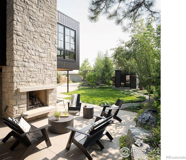 2828 4th St, Boulder, CO 80304 - view of patio / terrace with an outdoor stone fireplace