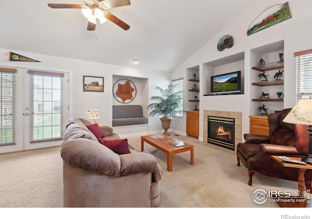 6911 W 22nd St, Greeley, CO 80634 - living area featuring light colored carpet, built in features, lofted ceiling, a tile fireplace, and ceiling fan