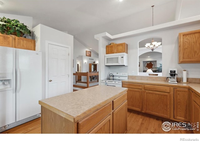 6911 W 22nd St, Greeley, CO 80634 - kitchen with white appliances, light wood-style flooring, a chandelier, light countertops, and vaulted ceiling