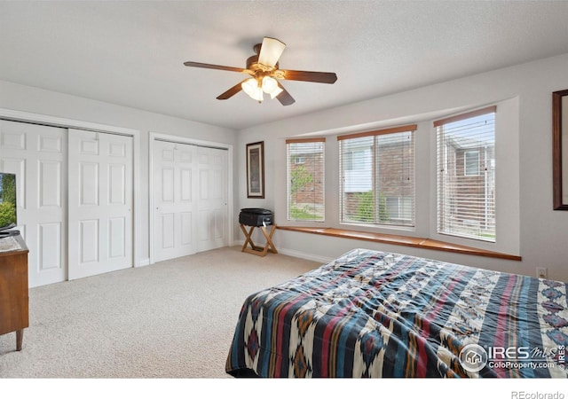 6911 W 22nd St, Greeley, CO 80634 - bedroom featuring two closets, carpet floors, baseboards, and ceiling fan