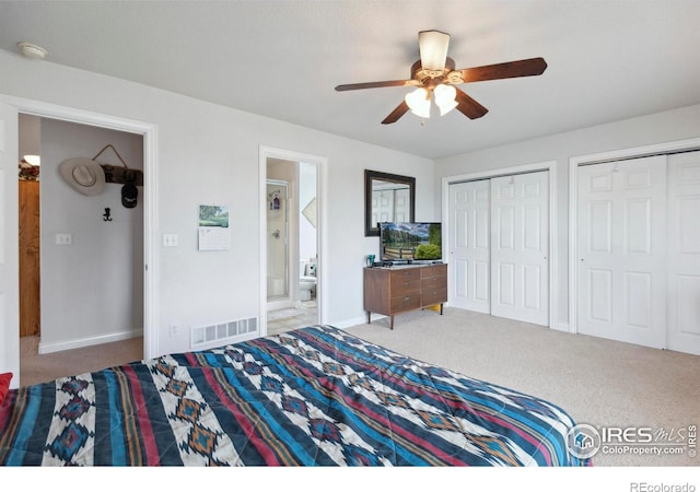 6911 W 22nd St, Greeley, CO 80634 - carpeted bedroom featuring two closets, baseboards, connected bathroom, and ceiling fan