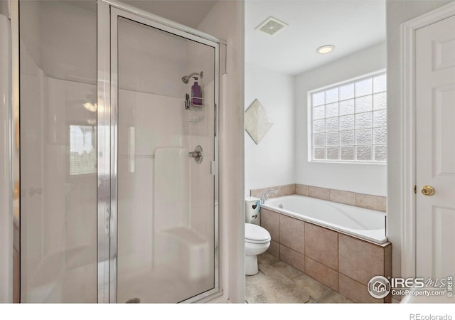6911 W 22nd St, Greeley, CO 80634 - bathroom featuring toilet, a stall shower, a bath, tile patterned flooring, and recessed lighting