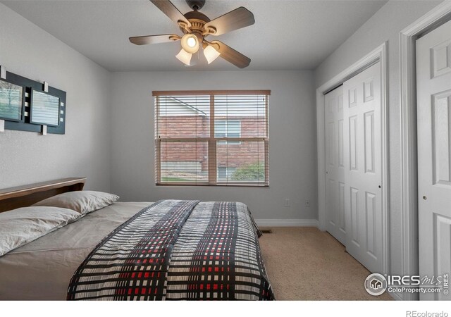 6911 W 22nd St, Greeley, CO 80634 - carpeted bedroom with a closet, baseboards, and a ceiling fan