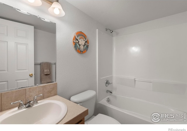 6911 W 22nd St, Greeley, CO 80634 - full bathroom with toilet, vanity, washtub / shower combination, and a textured wall