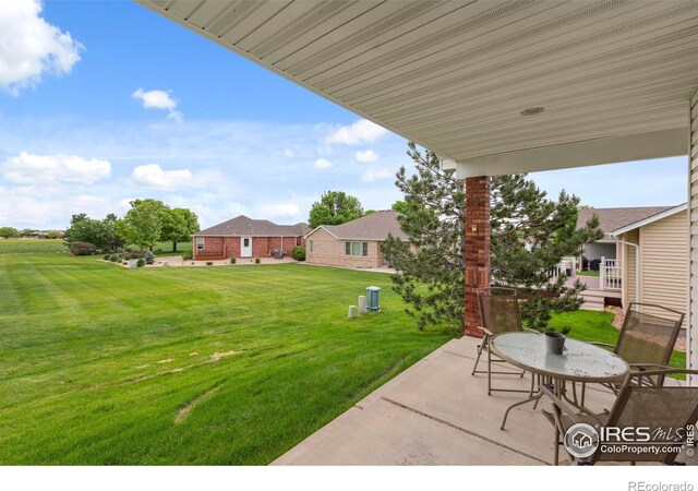 6911 W 22nd St, Greeley, CO 80634 - view of grassy yard with a patio area