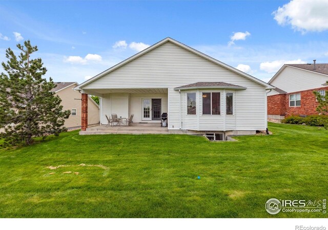 6911 W 22nd St, Greeley, CO 80634 - rear view of property featuring a patio area and a lawn