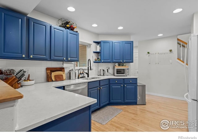 1409 Quince Ave, Boulder, CO 80304 - kitchen featuring stainless steel appliances, a sink, blue cabinetry, light wood finished floors, and recessed lighting