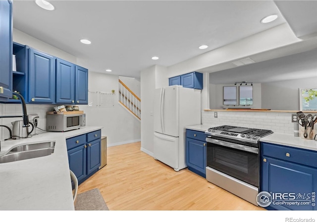 1409 Quince Ave, Boulder, CO 80304 - kitchen featuring stainless steel range with gas stovetop, freestanding refrigerator, blue cabinets, tasteful backsplash, and recessed lighting