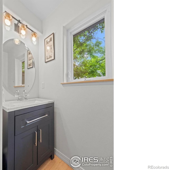 1409 Quince Ave, Boulder, CO 80304 - bathroom featuring vanity, wood finished floors, and baseboards