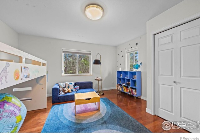 1409 Quince Ave, Boulder, CO 80304 - bedroom featuring multiple windows, wood finished floors, a closet, and baseboards