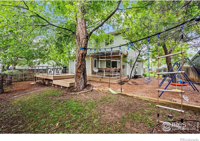 1409 Quince Ave, Boulder, CO 80304 - back of house featuring a fenced backyard, a wooden deck, and a playground