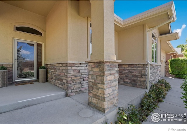 6787 Spanish Bay Dr, Windsor, CO 80550 - property entrance with stucco siding and stone siding