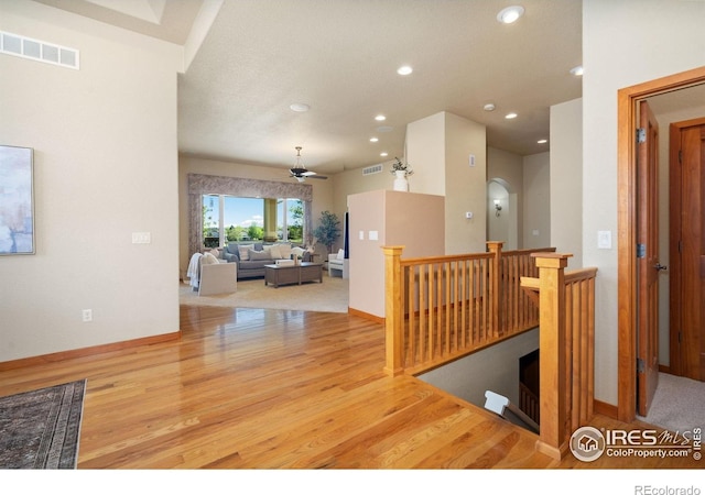 6787 Spanish Bay Dr, Windsor, CO 80550 - hallway featuring recessed lighting, wood finished floors, an upstairs landing, and baseboards