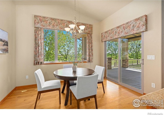 6787 Spanish Bay Dr, Windsor, CO 80550 - dining room featuring healthy amount of natural light, a chandelier, light wood-style flooring, lofted ceiling, and baseboards