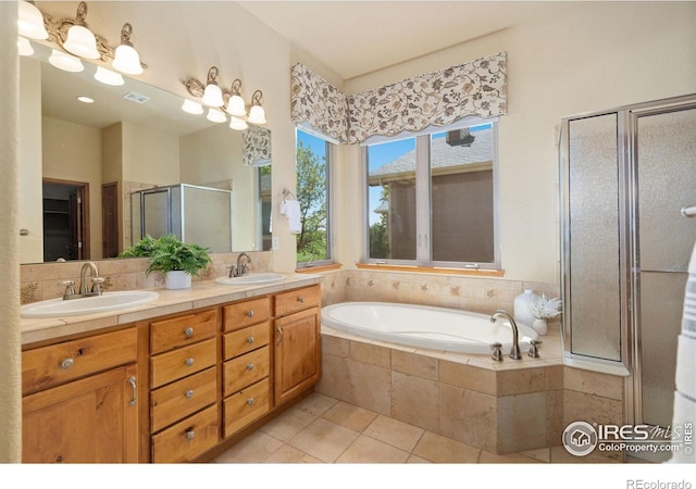 6787 Spanish Bay Dr, Windsor, CO 80550 - full bathroom with a shower stall, double vanity, a garden tub, and tile patterned floors