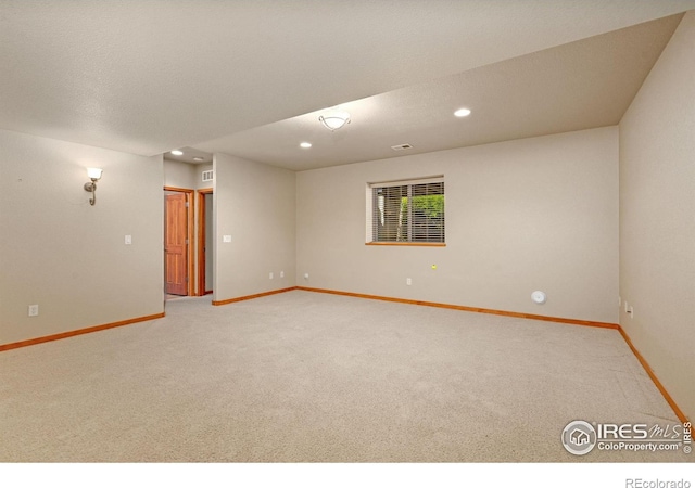 6787 Spanish Bay Dr, Windsor, CO 80550 - empty room featuring light colored carpet, baseboards, and recessed lighting