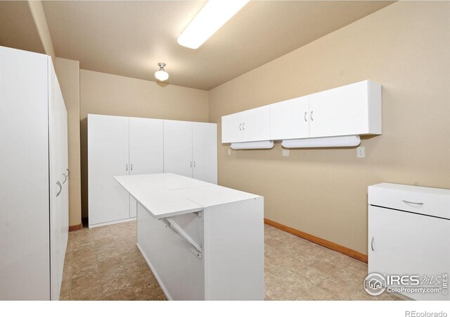 6787 Spanish Bay Dr, Windsor, CO 80550 - laundry room with baseboards