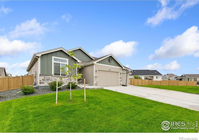 7025 Meadow Rain Way, Wellington, CO 80549 - view of front of home with board and batten siding, concrete driveway, stone siding, and an attached garage