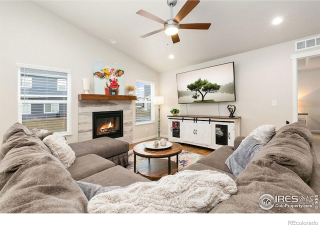 7025 Meadow Rain Way, Wellington, CO 80549 - living room with vaulted ceiling, ceiling fan, a fireplace, recessed lighting, and wood finished floors