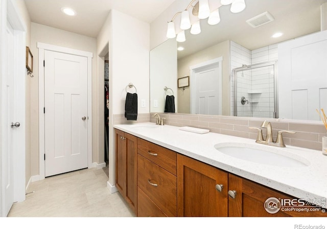 7025 Meadow Rain Way, Wellington, CO 80549 - bathroom with a stall shower, double vanity, a spacious closet, baseboards, and recessed lighting
