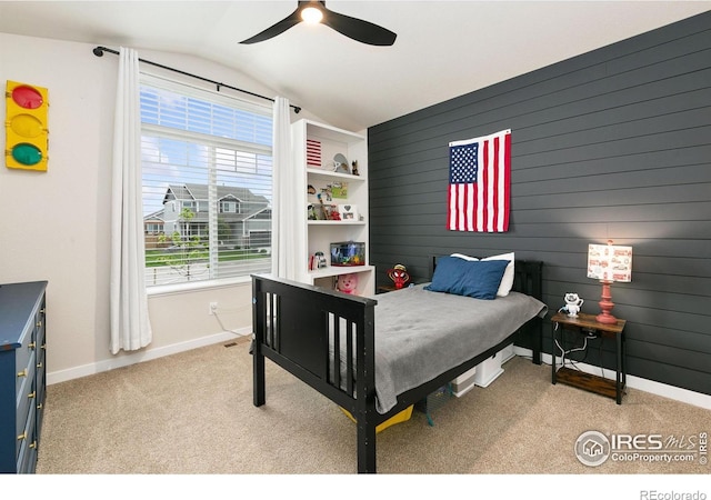 7025 Meadow Rain Way, Wellington, CO 80549 - carpeted bedroom featuring vaulted ceiling, baseboards, a ceiling fan, and wooden walls