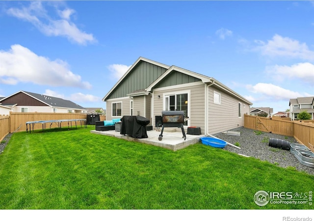 7025 Meadow Rain Way, Wellington, CO 80549 - rear view of house featuring a trampoline, board and batten siding, and a patio area