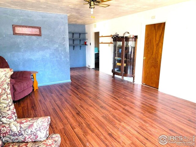 402 N Washington Ave, Fleming, CO 80728 - living area with wood finished floors and ceiling fan