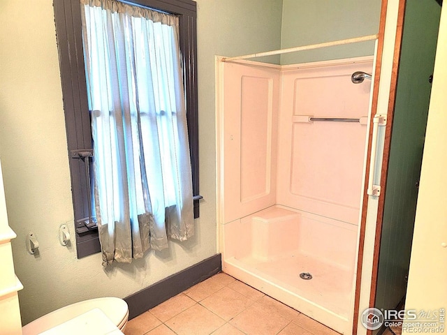 402 N Washington Ave, Fleming, CO 80728 - full bathroom featuring tile patterned floors, a shower stall, toilet, and baseboards