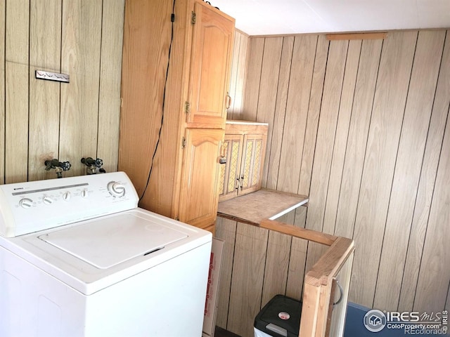 402 N Washington Ave, Fleming, CO 80728 - washroom with washer / clothes dryer, cabinet space, and wooden walls