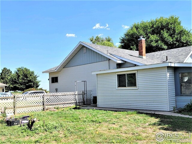 402 N Washington Ave, Fleming, CO 80728 - rear view of house featuring a chimney and a shingled roof