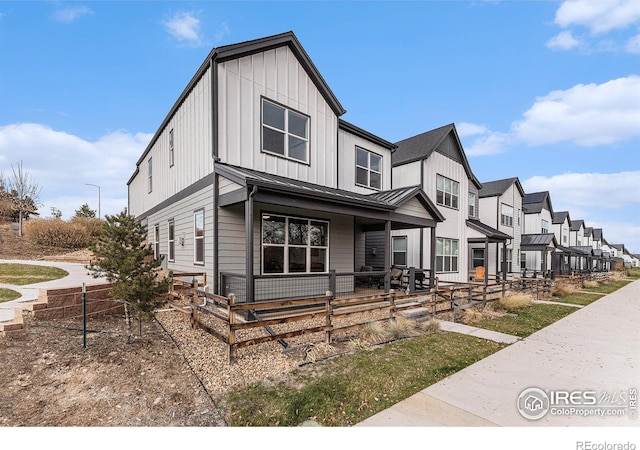 3580 W 62nd Pl, Denver, CO 80221 - view of front of home featuring a porch, a standing seam roof, board and batten siding, and metal roof