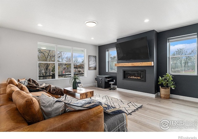 3580 W 62nd Pl, Denver, CO 80221 - living room featuring light wood finished floors, a large fireplace, recessed lighting, and baseboards